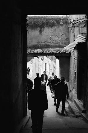 Free Photo Of People In A Narrow Alley In Black And White