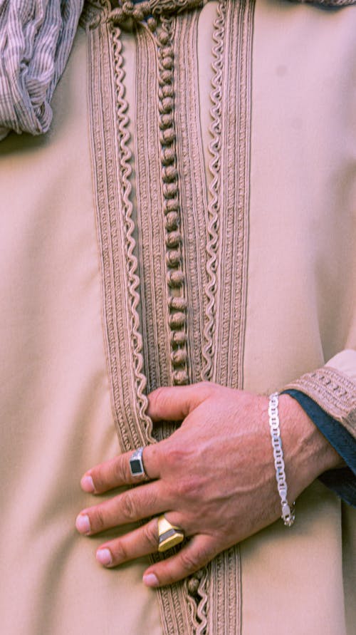 Free Detailed view of a hand on traditional Moroccan attire in Rabat, showcasing cultural elegance. Stock Photo