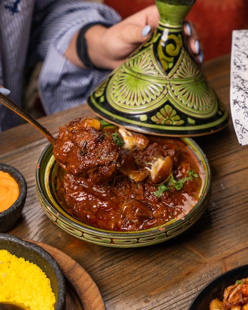 Free Authentic Moroccan lamb tagine served hot in a traditional dish. Perfect blend of flavors. Stock Photo