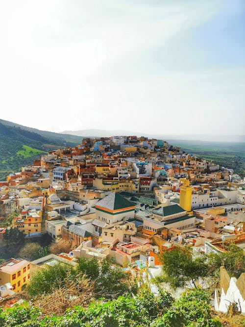 Free Discover the vibrant urban landscape of Moulay Idriss Zerhoun, Morocco, captured from above. Stock Photo