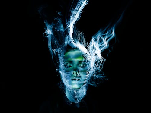 Free A hauntingly beautiful portrait of a woman with abstract light effects creating a surreal, ethereal appearance. learning deep connection