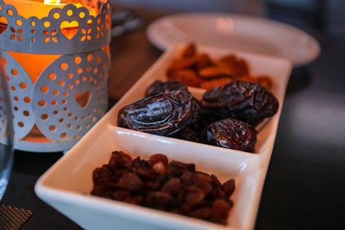 Free Close-up of dried dates and lantern symbolizing Ramadan traditions. Ideal for festive themes. Stock Photo