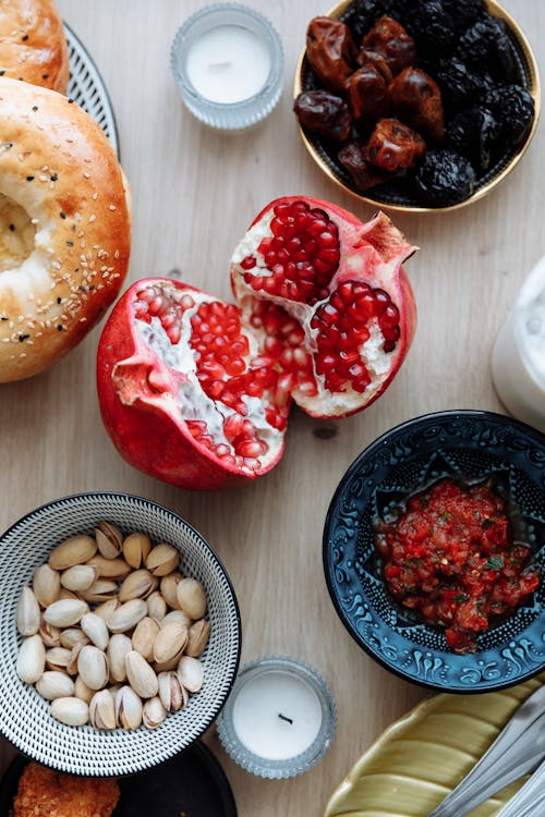 Free Top view of healthy breakfast with pomegranate, dates, and nuts. Stock Photo