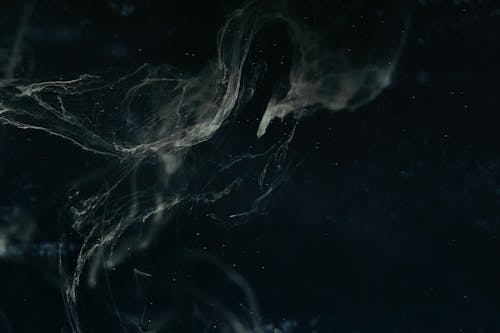 Free Abstract dark nebula image with swirling patterns and ethereal textures creating a cosmic feel. Stock Photo