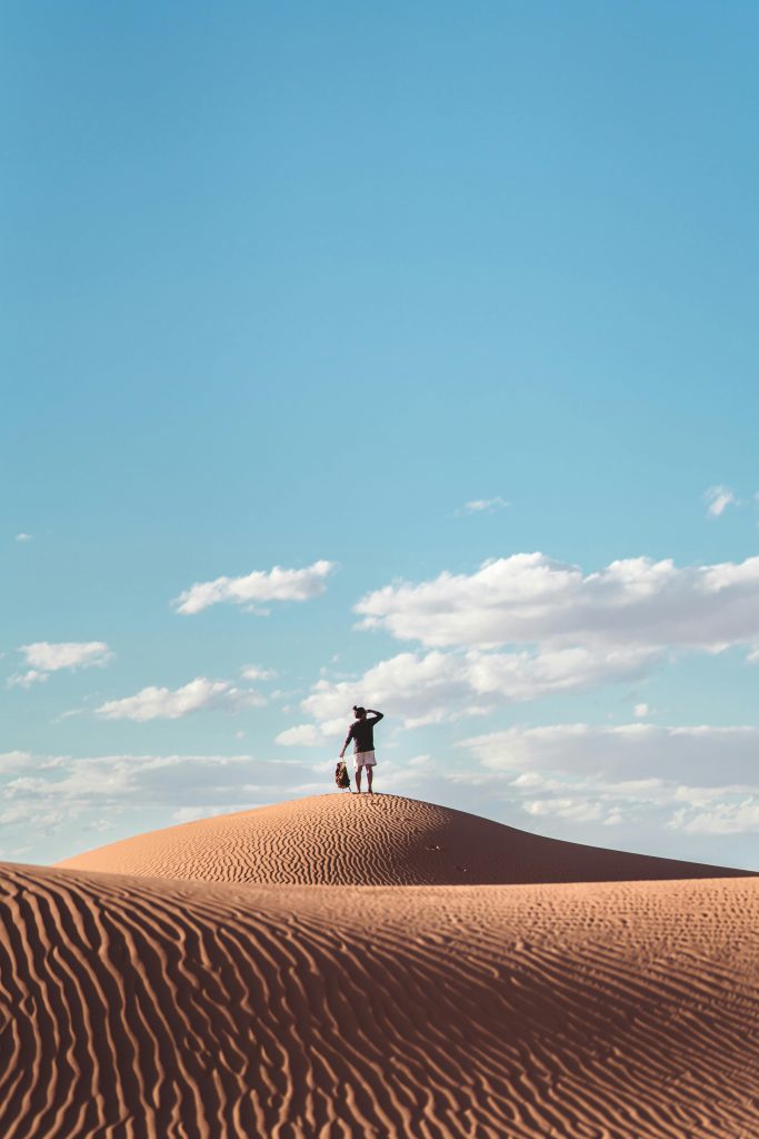 A tourist sandboarding in Dakhla, Morocco