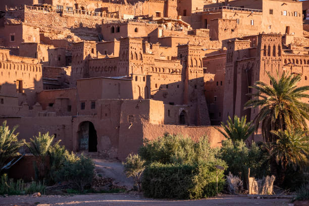 Sunrise over the beautiful historic town Ait Ben Haddou, famous berber town with many kasbahs built of clay, UNESCO world heritage Sunrise over the beautiful historic town Ait Ben Haddou in Morocco, famous berber town with many kasbahs built of clay, UNESCO world heritage casbah telouet stock pictures, royalty-free photos & images