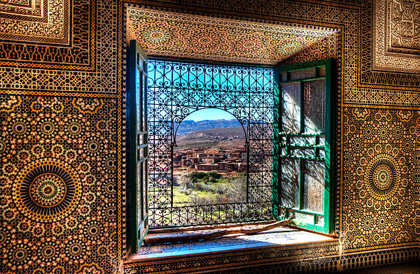 Window, Kasbah Telouet, Morocco An ornate window in the Kasbah Telouet in Morocco overlooks the fields and Atlas Mountains casbah telouet stock pictures, royalty-free photos & images