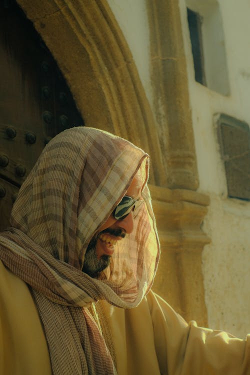 Free A man in traditional Moroccan clothing standing near a historic building in Rabat, Morocco. Stock Photo
