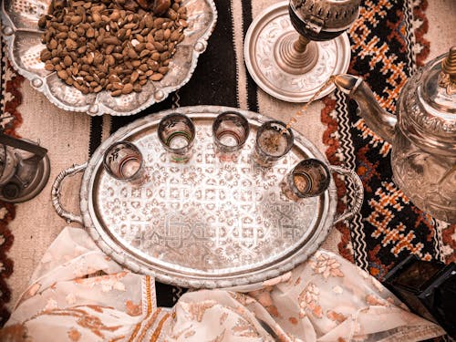 Free Elegant Moroccan tea setup on a decorative tray with almonds in Marrakesh, Morocco. Stock Photo