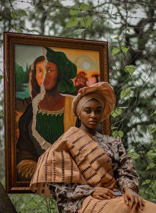 Free Elegant portrait of a woman in traditional attire with art backdrop in Abuja. Stock Photo