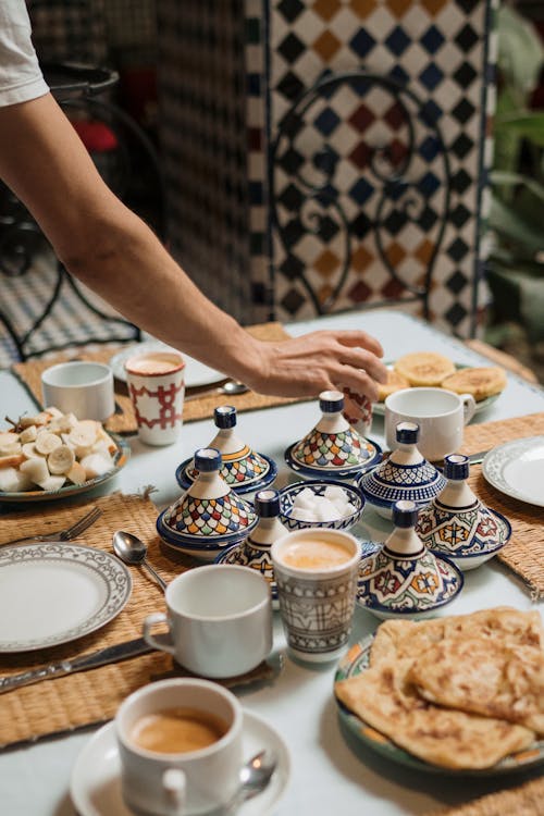 Free A beautifully arranged Moroccan breakfast table with colorful ceramics and traditional dishes. Stock Photo