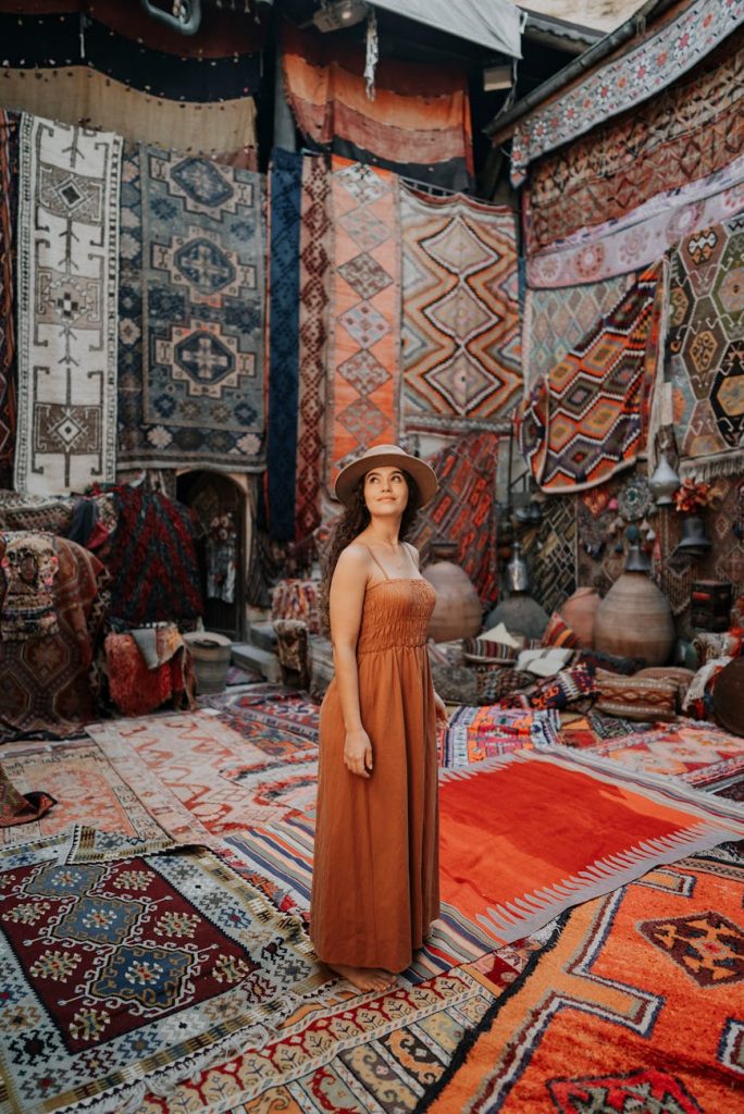 a woman standing in front of a rug