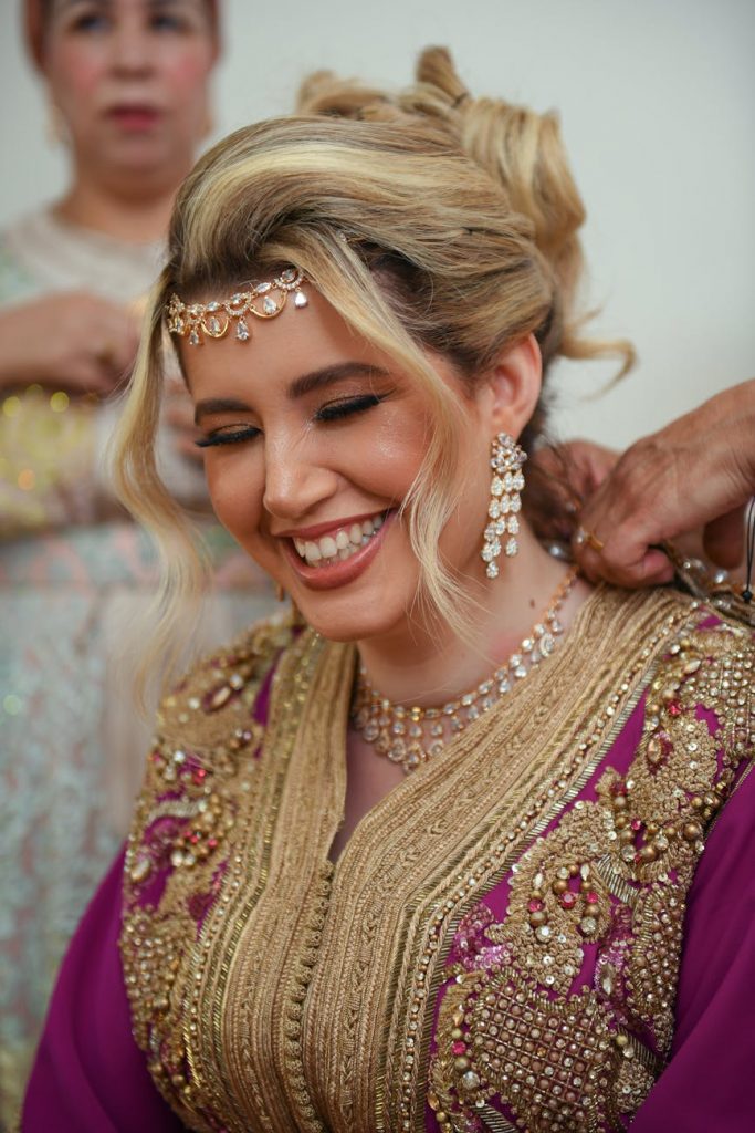 a woman in traditional indian clothing getting ready for her wedding