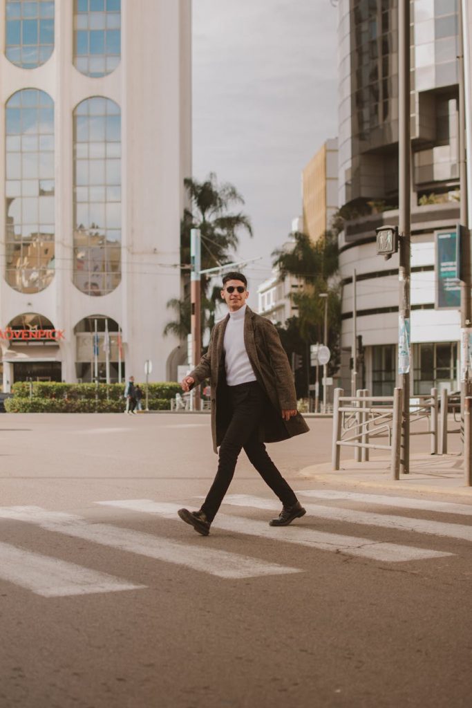 stylish man crossing street in modern cityscape