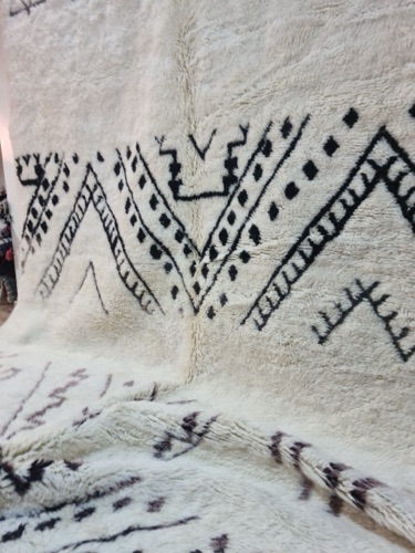 Minimalist interior with a statement Mrirt rug, supporting women artisans in Morocco through SheandElle of Morocco